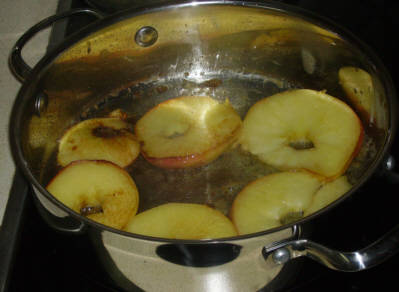 Sauteeing the apple rings begins while the pork chops are browning.